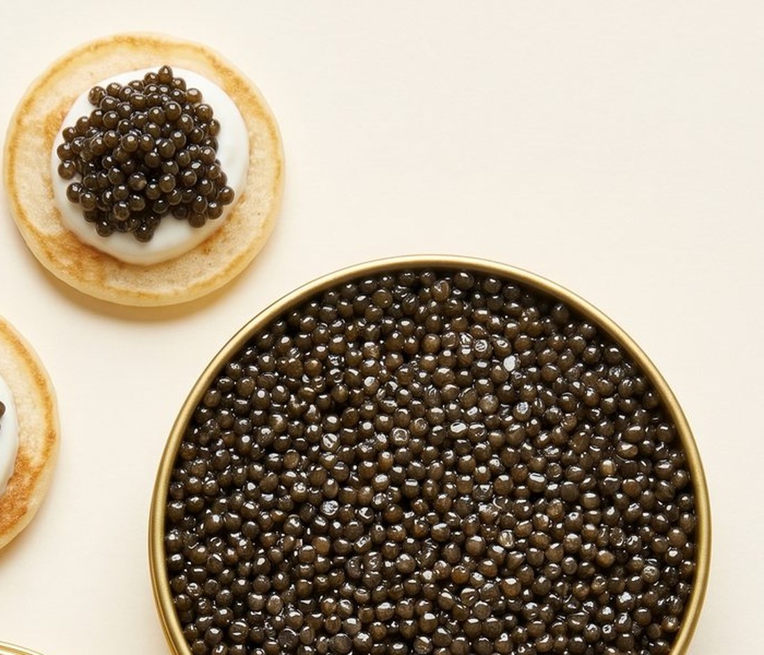 Blini with caviar and crème fraîche on a simple tabletop